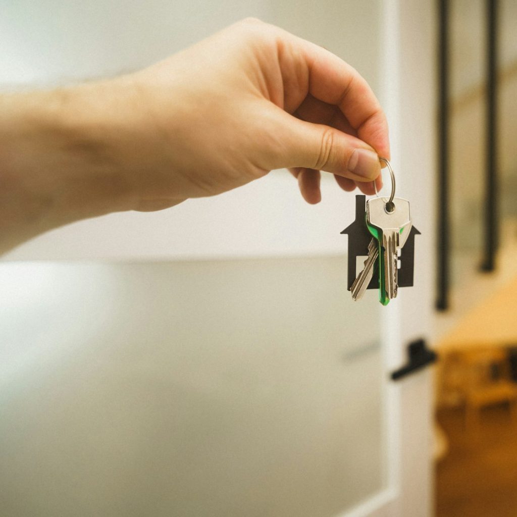 Hand holding the key to a new destination property