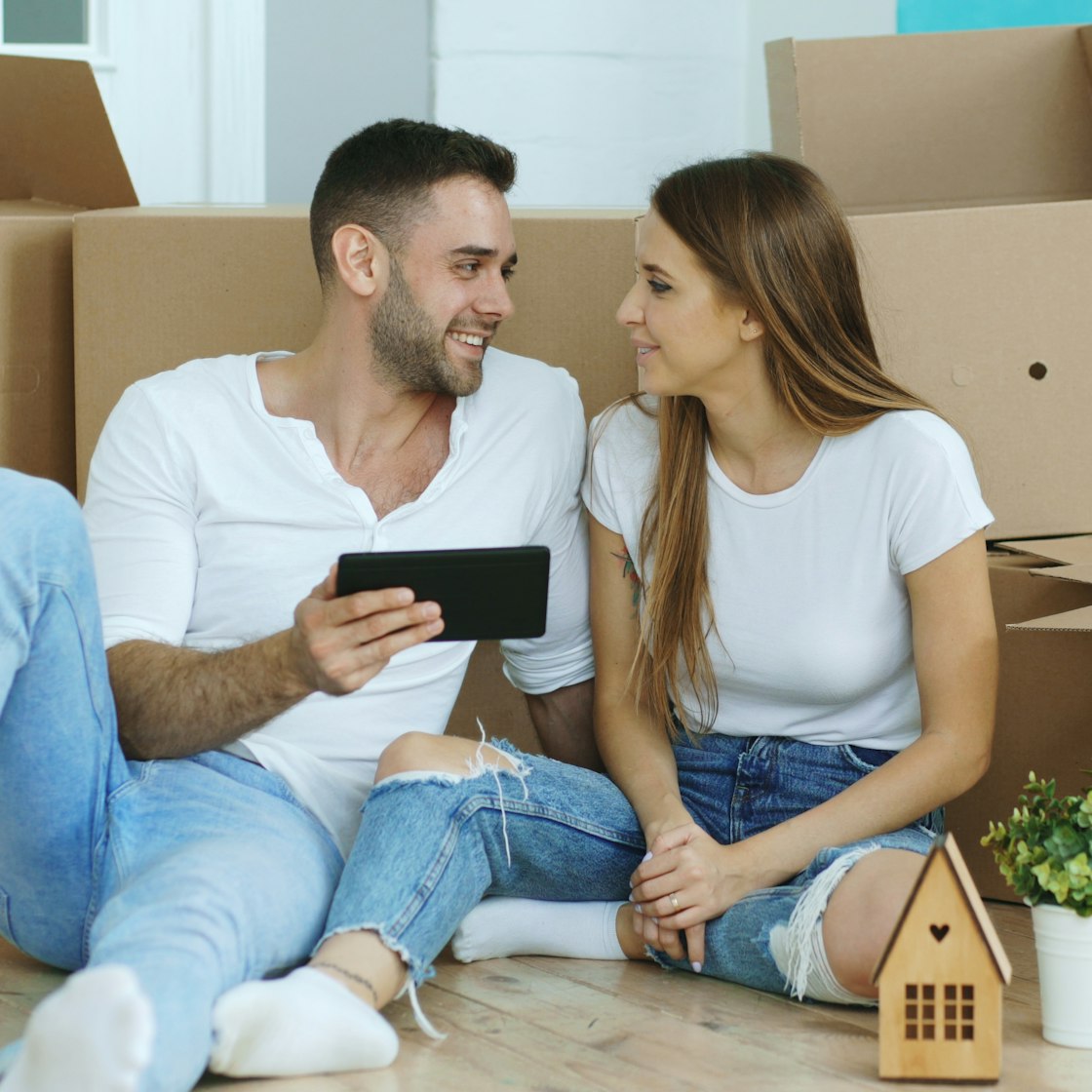 Couple planning their Fort Worth move surrounded by packed boxes